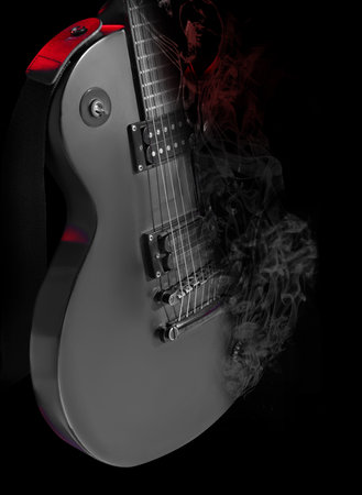 Electric guitar and smoke on black background, closeup. Color toned stylish design. rock music conceptの写真素材