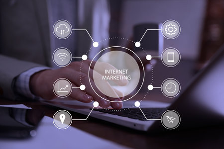 internet marketing. Different virtual icons and businessman working on modern laptop at table, closeupの写真素材