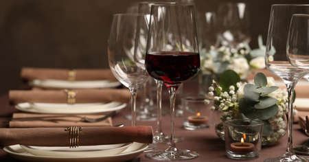 Glass of delicious wine and elegant table setting in restaurant. banner design