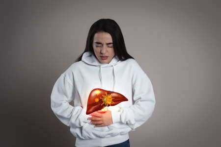 Sick woman suffering from pain and illustration of unhealthy liver on light blue background. viral...