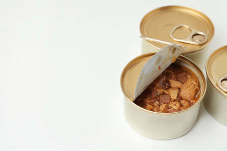 Tin cans with wet cat food on white background. Space for text