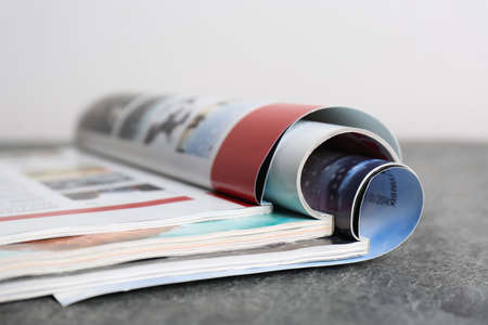 Three open magazines on gray stone table, closeupの写真素材
