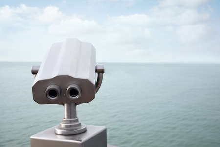Metal tower viewer installed near sea, space for text. Mounted binocularsの写真素材