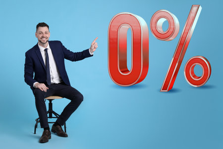 Handsome man pointing at sign Zero Percent on light blue background. special promotion
