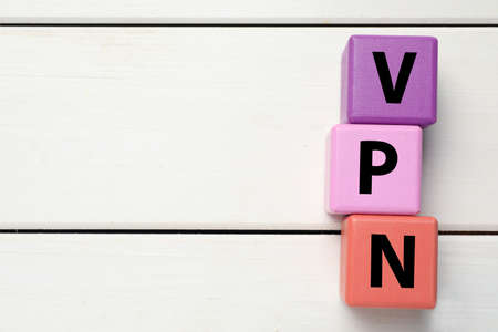 Color cubes with acronym VPN on white wooden background, flat lay. Space for textの写真素材