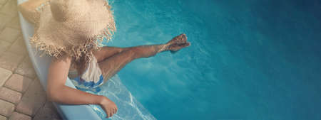 African American woman resting in outdoor swimming pool on sunny day, banner designの写真素材