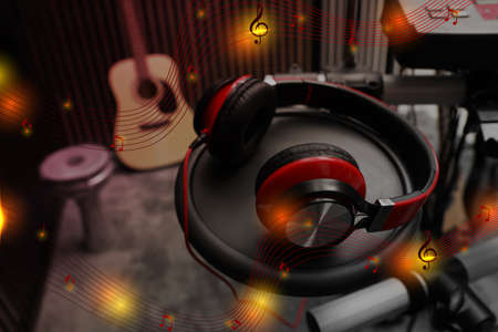 Modern headphones with illustration musical notes at recording studioの写真素材