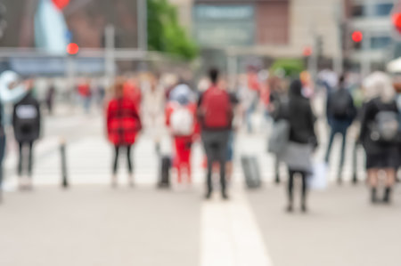 People waiting to cross street in city, blurred viewの写真素材