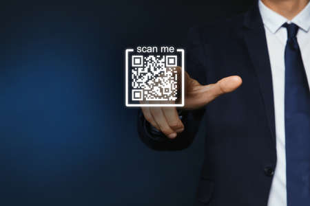 Man pointing at illustration of QR code on dark blue background, closeup