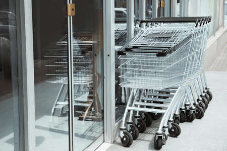 Row of shopping carts near store outdoors
