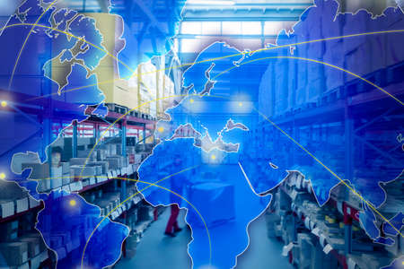 worldwide logistics. Man working with pallet truck at warehouse and illustration of mapの写真素材