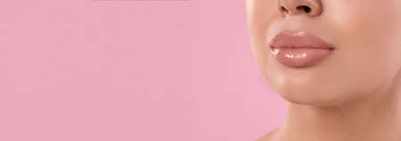 Woman with beautiful lips on pink background, closeup view with space for text. banner design