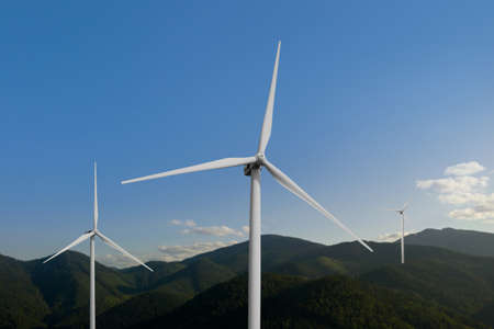 Modern wind turbines in mountains on sunny day. alternative energy sources
