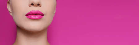 Woman with beautiful lips on pink background, closeup view with space for text. banner design