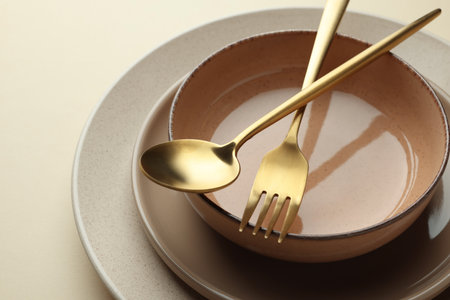 Stylish empty dishware and cutlery on beige background, closeupの写真素材
