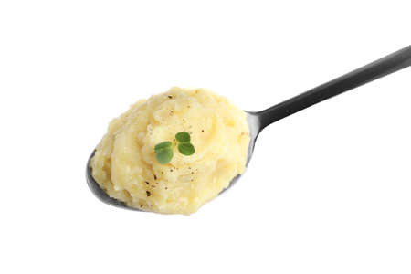 Spoon of tasty mashed potatoes with microgreen and black pepper isolated on white, top viewの写真素材