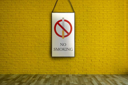 Sign No Smoking hanging on yellow brick wallの写真素材