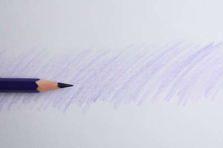 Purple pencil on sheet of paper with drawing, top viewの写真素材