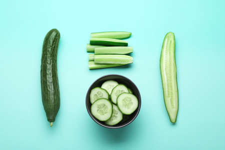 Fresh ripe cucumbers on light blue background, flat layの写真素材