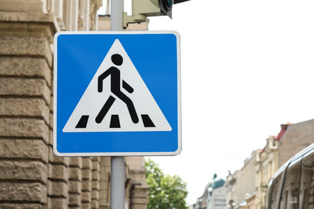 Post with Pedestrian Crossing road sign in cityの写真素材