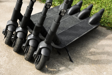 Row of electric scooters outdoors, closeup. rental service