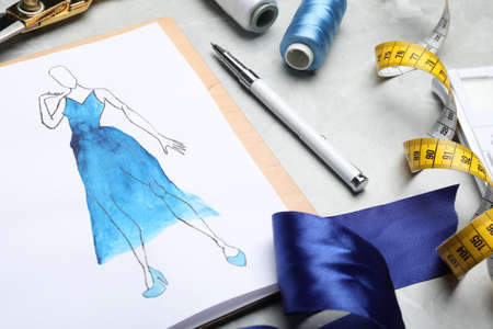 Drawing of dress on table, closeup. Designer's workplace