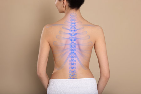 Woman with healthy spine on beige background, back viewの写真素材