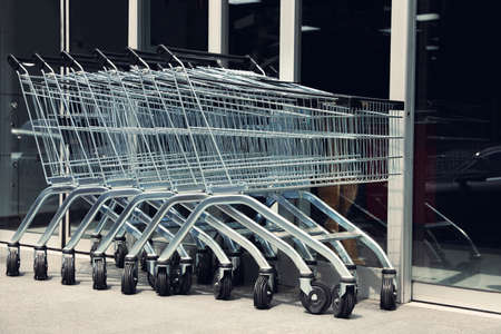 Row of shopping carts near store outdoorsの写真素材