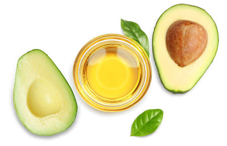 Cooking oil and ripe avocados on white background, top view