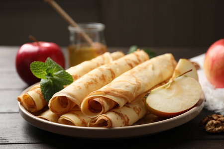 Delicious rolled thin pancakes on wooden tableの写真素材