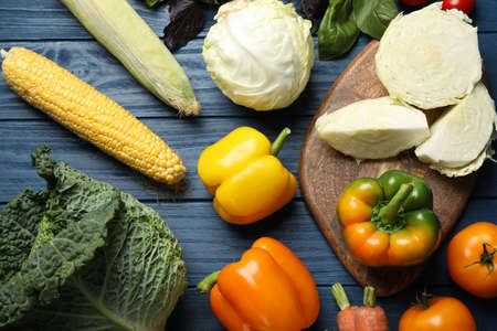 Fresh ripe vegetables on blue wooden table, flat layの写真素材