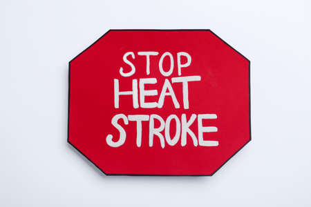Sign with phrase Stop Heat Stroke on white background, top view