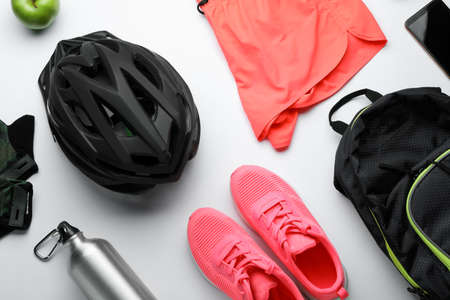 Flat lay composition with different cycling accessories and clothes on white backgroundの写真素材