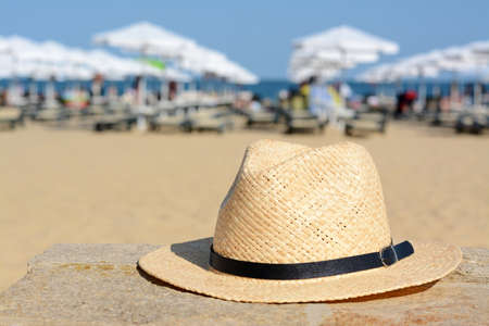 Stylish straw hat on stone surface near sea, space for textの写真素材