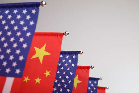 USA and China flags on light background, closeup. international relationsの写真素材