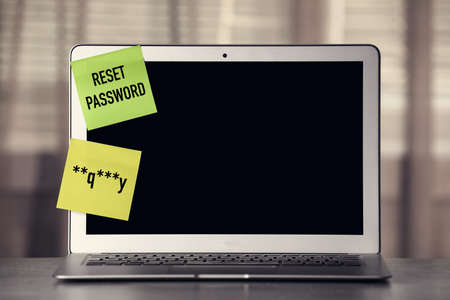 Sticky notes with passcode and phrase Reset Password on laptop. Space for textの写真素材