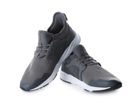 Pair of stylish gray sneakers on white background