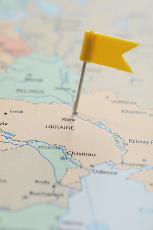 MYKOLAIV, UKRAINE - NOVEMBER 09, 2020: Kyiv city marked with push pin on political map Eastern Europe, closeupのeditorial素材