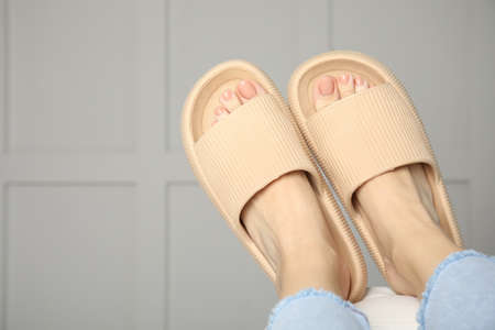 Woman wearing comfortable rubber slippers indoors, closeupの写真素材