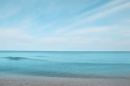 Beautiful view of sea shore under blue sky on sunny dayの写真素材