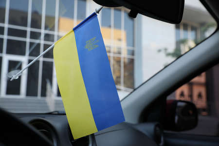 National flag of Ukraine on windshield inside car