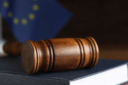 Wooden judge's gavel and book on table against European Union flag, closeupの写真素材