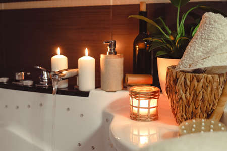 Bath with burning candles indoors. Creating a romantic atmosphereの写真素材