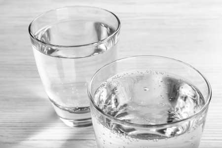Glasses of soda water on white wooden table, closeupの写真素材