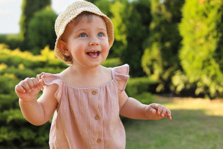 Cute little girl wearing stylish clothes outdoors on sunny dayの写真素材