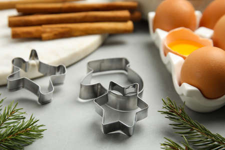Cookie cutters and eggs on light gray table, closeup. christmas biscuitsの写真素材