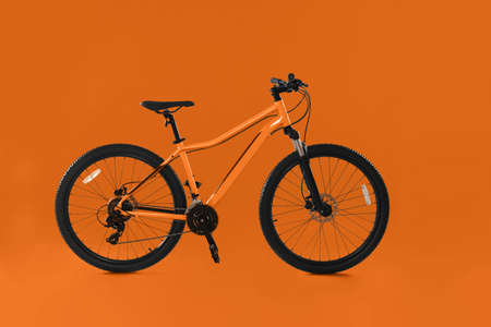 Modern bicycle on orange background. healthy lifestyle