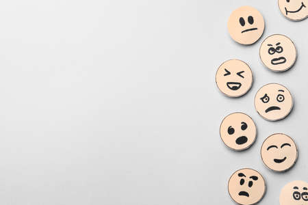 Many faces with different emotions on gray background, flat lay. Space for textの写真素材