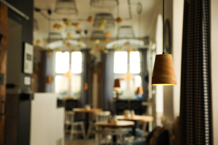 Stylish cafe interior with furniture, blurred viewの写真素材