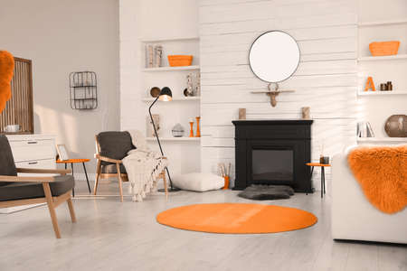 Cozy living room interior with comfortable furniture and modern electric fireplaceの写真素材